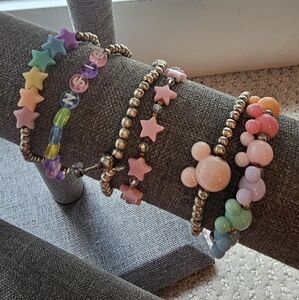 Six silver coloured elastic beaded bracelets